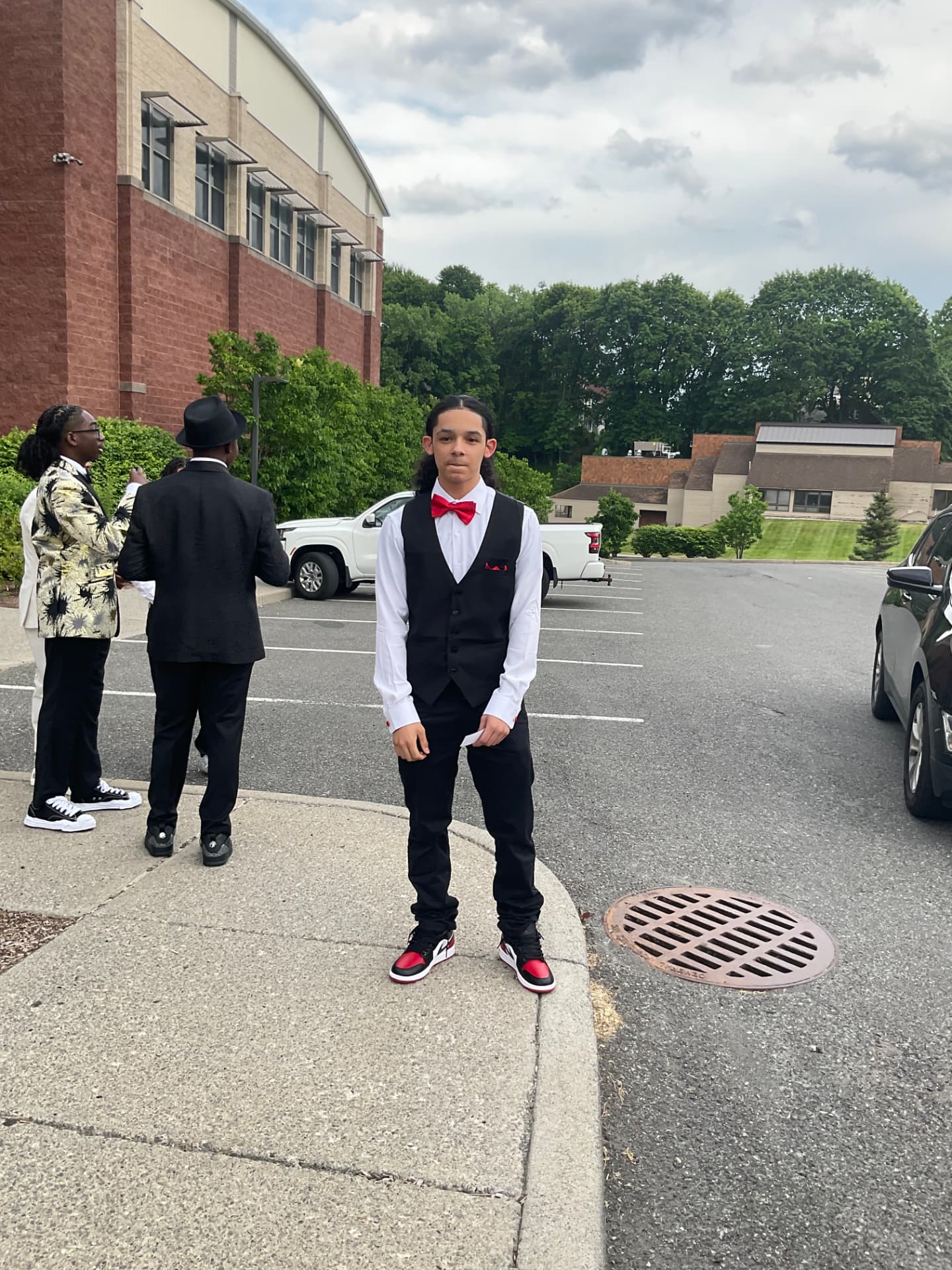 A Green Tech Charter School student in a vest and bow tie before the formal