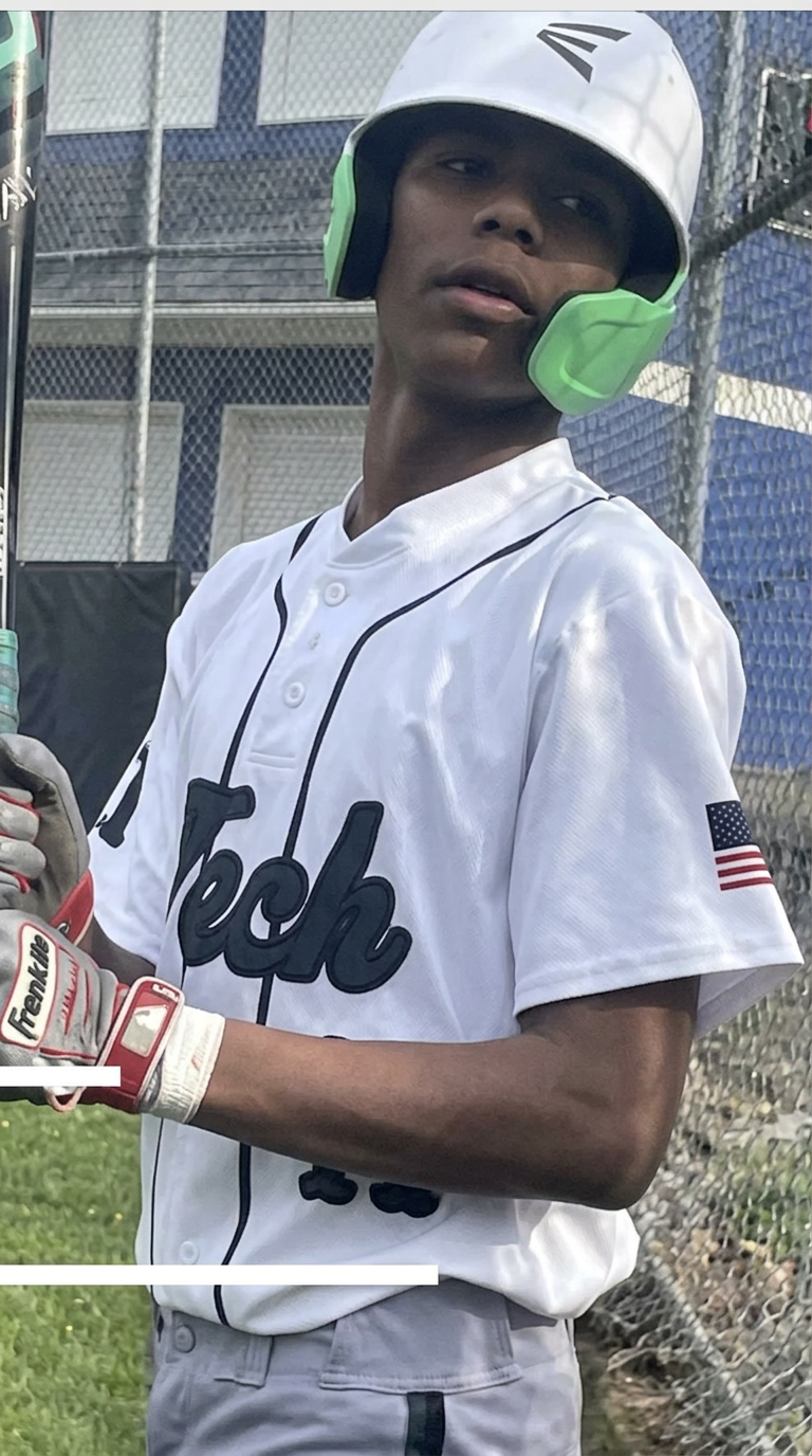 Green Tech Charter School Eagles baseball player at bat in a white and green uniform