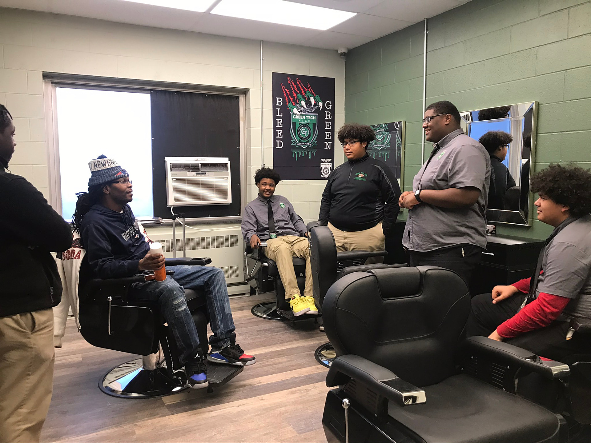 Green Tech Charter School students and their barbering instructor in the school's on-campus barbershop classroom in Albany, NY